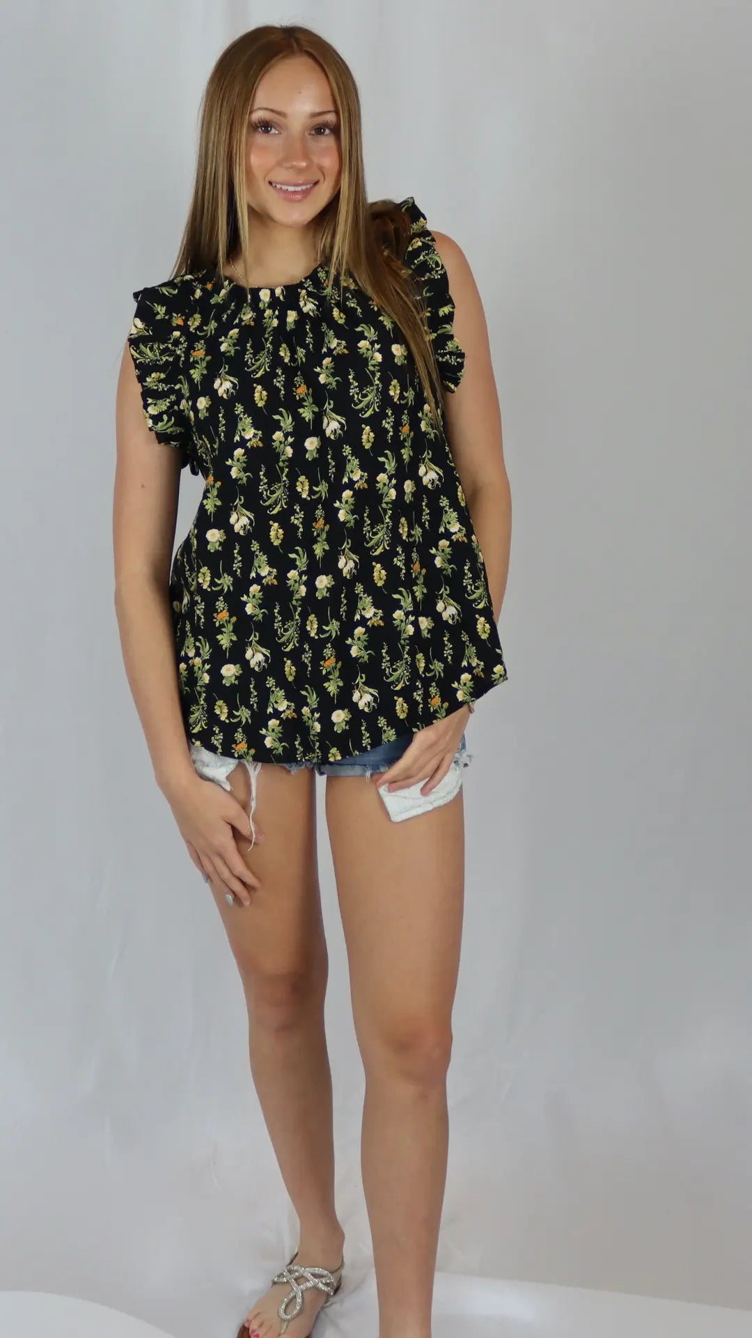 Black floral top with small yellow flowers and flowy fit