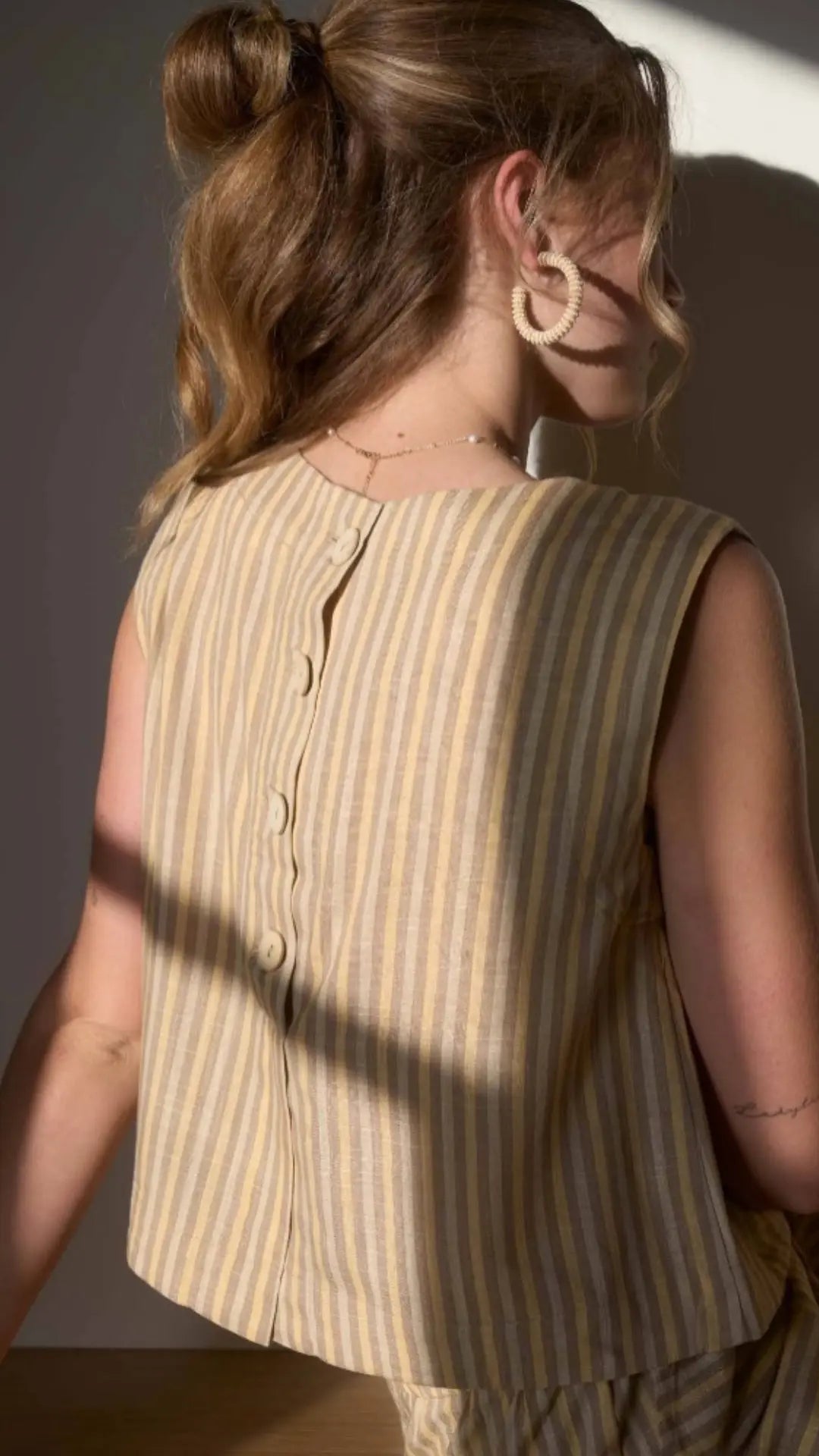 Back button detail on striped linen top with matching set