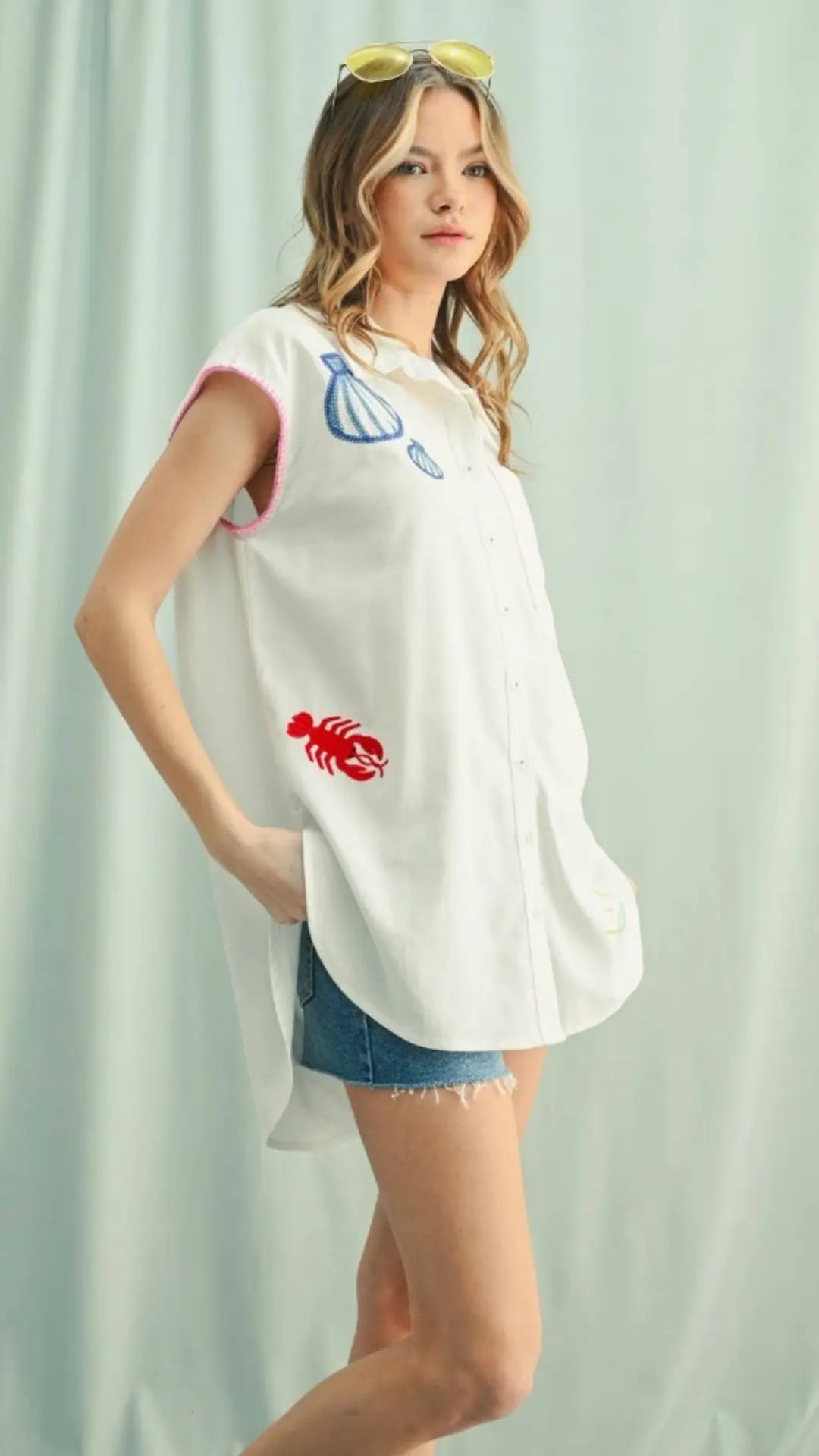 White embroidered tunic with pink trim and coastal motifs