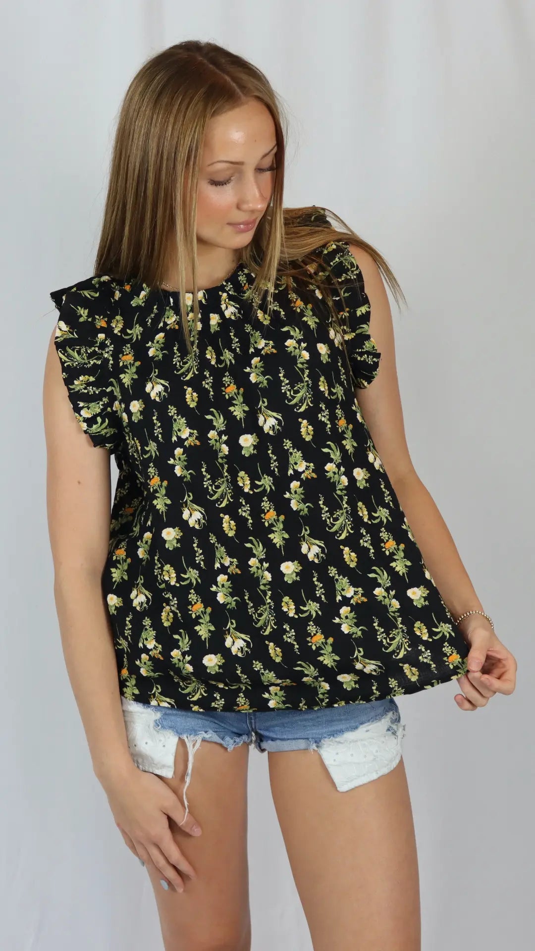 Black blouse with yellow floral print and lightweight silhouette