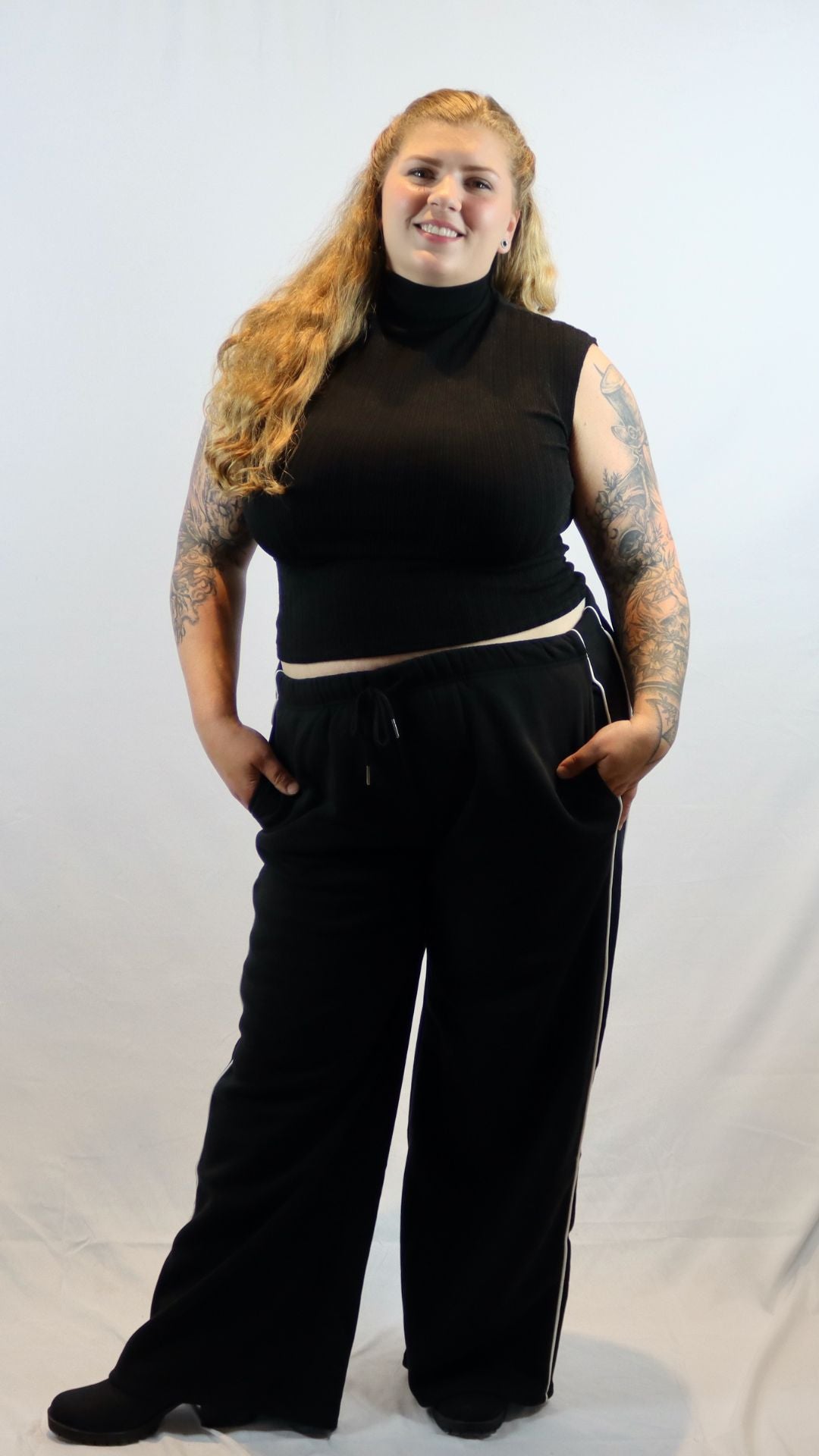 Plus size black wide leg sweatpants with a white stripe down the side