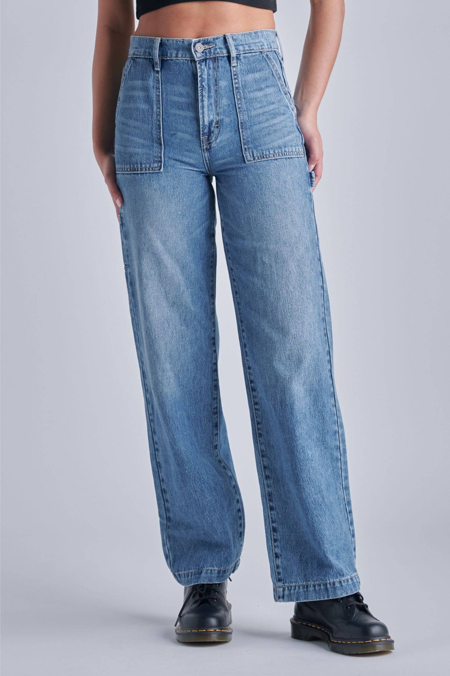 Light wash carpenter dad jeans with a loose fit and pockets