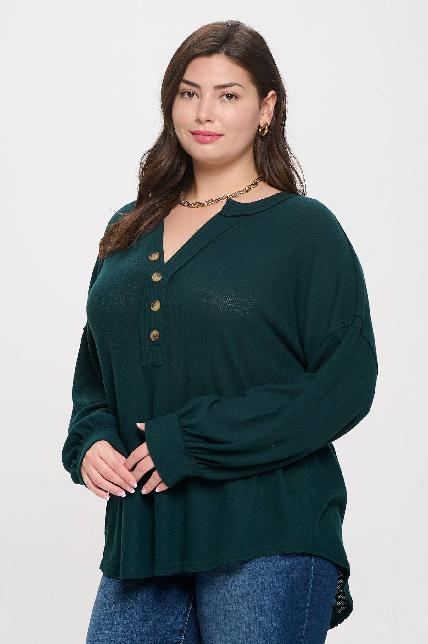 Plus-size V-neck knit top with half-button detail and long sleeves