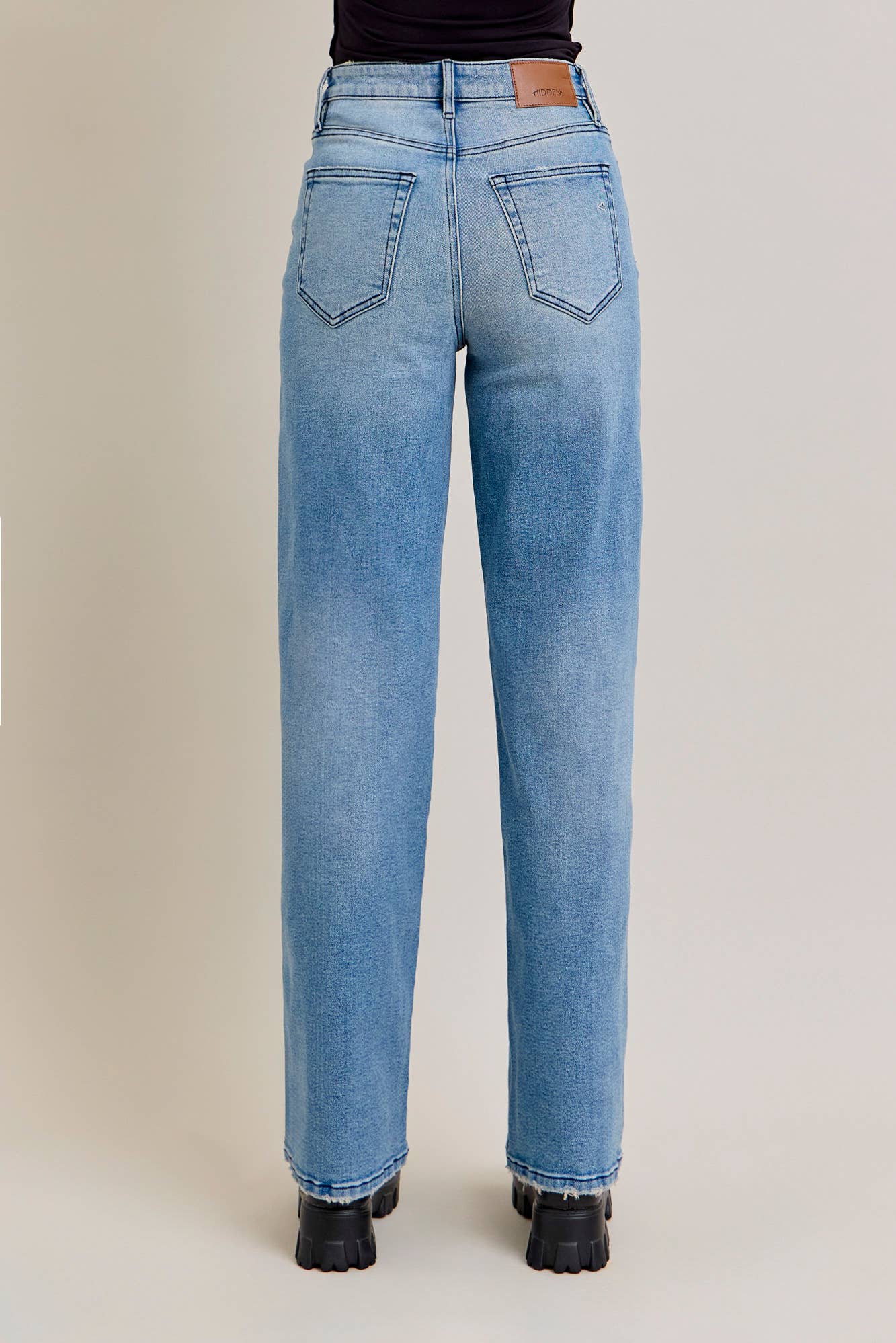 Medium wash stretch dad jeans with curved seam design