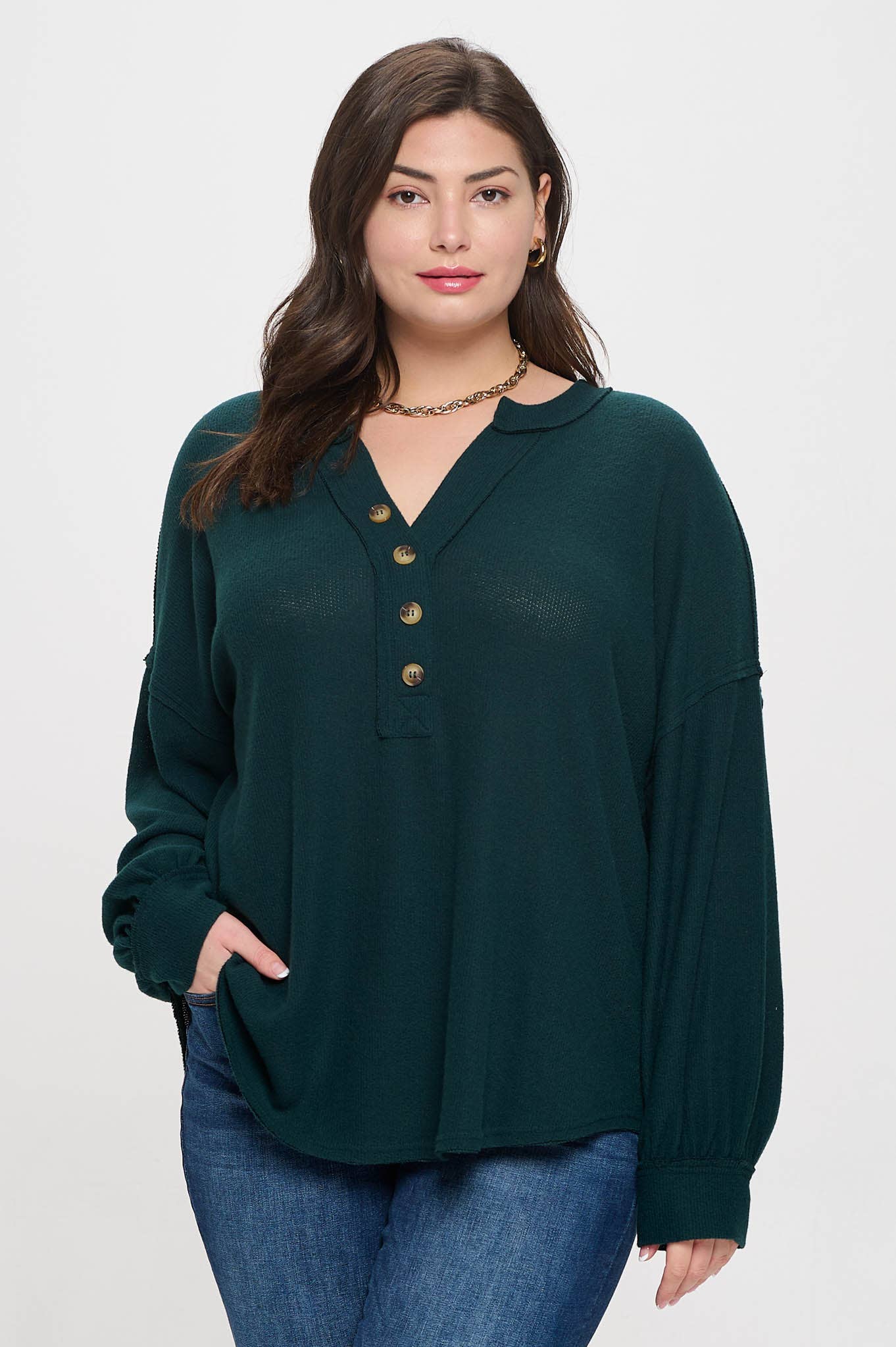 Plus-size V-neck knit top with half-button detail and long sleeves