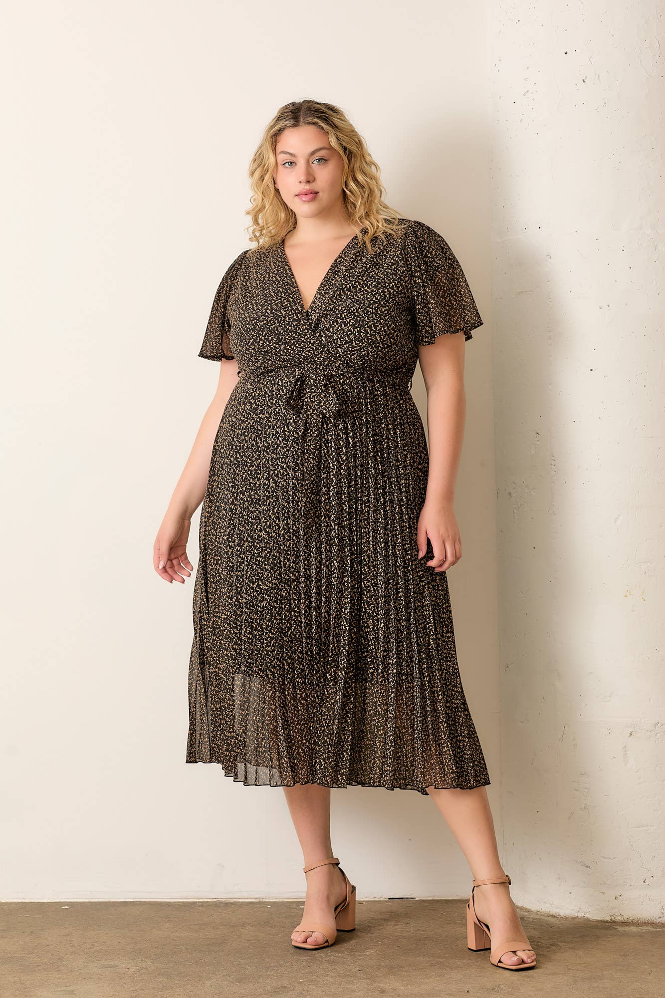 Plus-size dress with surplice neckline and pleated skirt